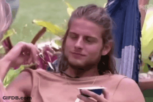 Man With Long Hair Sitting In Hammock Holding Coffee GIF