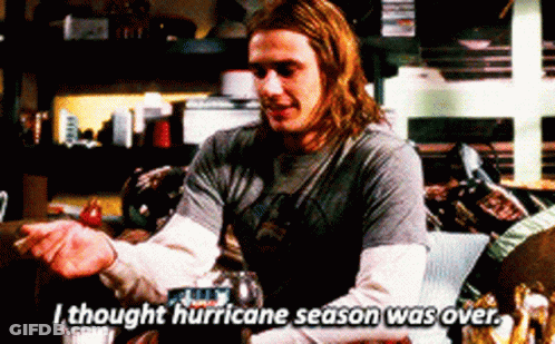 Man With Long Hair Sitting On Couch Says I Thought Hurricane Season Was Over GIF