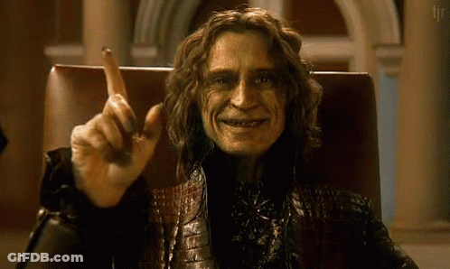 Man With Long Hair Sitting With Finger Up GIF