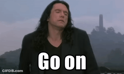 Man With Long Hair Standing In Front Of Go On Sign GIF