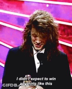 Man With Long Hair Talking Into Microphone Says I Didn't Expect To Win Anything Like This GIF