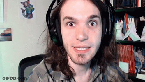 Man With Long Hair Wearing Headphones And Plaid Shirt Smiling GIF