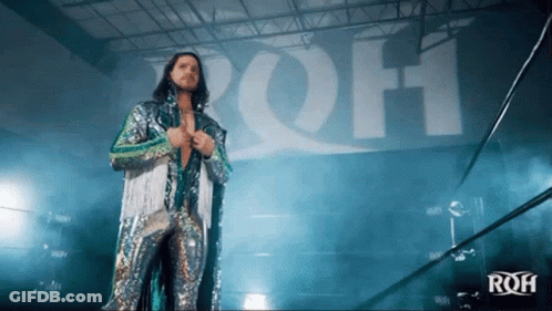 Man With Long Hair Wearing Mask Holding Blue Feather GIF