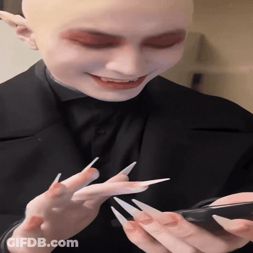 Man With Long Nails Looking At Phone GIF