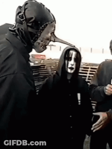 Man With Long Nose Mask Talks To Another Man GIF