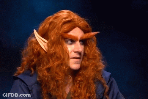 Man With Long Red Hair And Elf Ears Looking At Camera GIF
