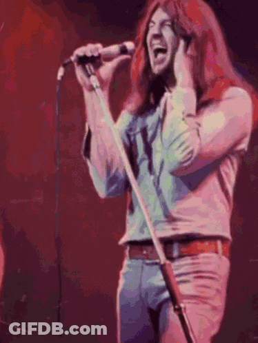 Man With Long Red Hair Singing Into Microphone GIF
