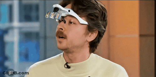 Man With Magnifying Glass On Head BT GIF