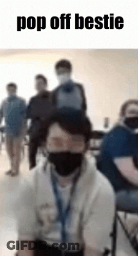 Man With Mask And Backpack On Head In Classroom GIF