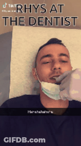 Man With Mask Getting Teeth Checked By Dentist GIF