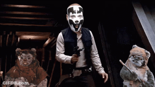 Man With Mask Holding Gun Next To Ewok Bears GIF
