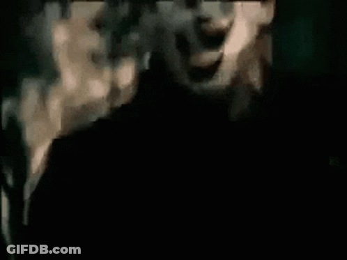 Man With Mask Screaming In Dark Room GIF