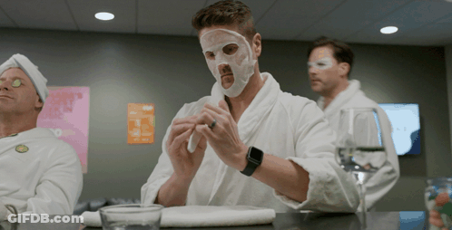 Man With Mask Sitting At Table With Two Men GIF