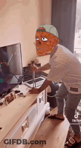 Man With Mask Standing In Front Of Laptop And Television GIF