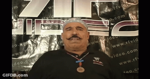 Man With Medal In Front Of RFVD Sign GIF