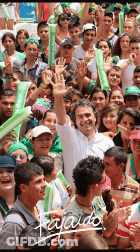 Man With Mejor Sign In Front Of Crowd GIF