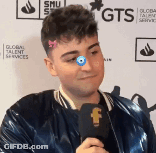 Man With Microphone In Front Of GTS Wall GIF