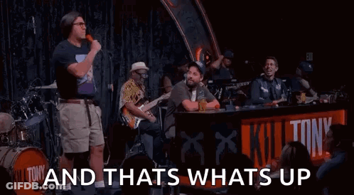 Man With Microphone On Stage With Band And Crowd GIF