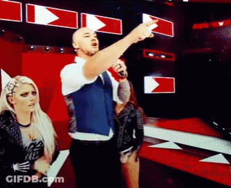 Man With Microphone Pointing As Woman Watches GIF