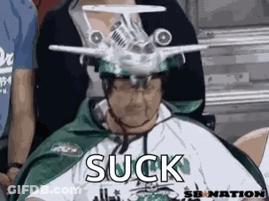 Man With Model Airplane Hat In Stadium GIF