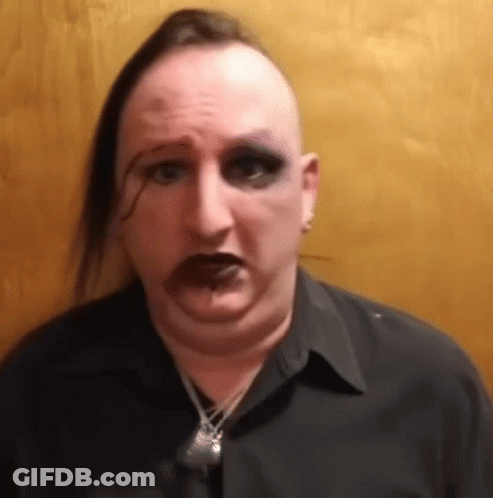 Man With Mohawk And Necklace Making Funny Face GIF