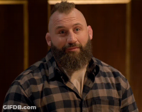 Man With Mohawk Beard And Plaid Shirt Looking At Camera GIF