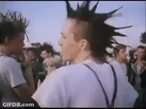Man With Mohawk In Front Of Crowd GIF