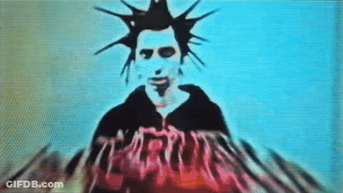 Man With Mohawk In Front Of Screen Saying Jesus GIF