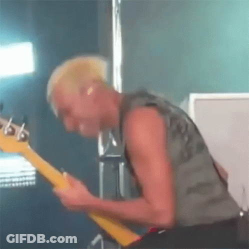 Man With Mohawk Playing Guitar On Stage GIF