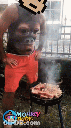 Man With Monkey Face Shirt Grilling Meat GIF