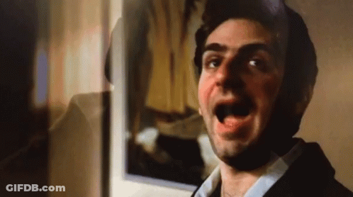 Man With Mouth Open In Front Of Mirror GIF