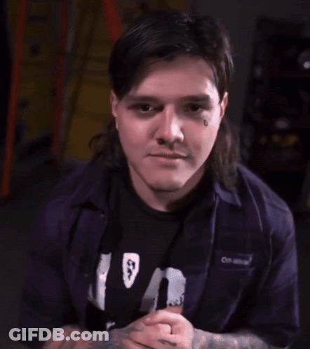 Man With Mullet Smiling And Waving GIF
