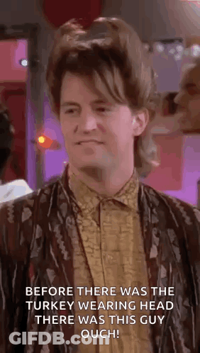 Man With Mullet Standing In Room With Purple Background GIF