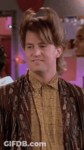 Man With Mullet Wearing Jacket And Shirt Smiling GIF