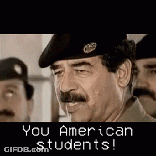 Man With Mustache And Beret Talking To Two Men GIF