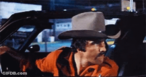 Man With Mustache And Cowboy Hat Driving Car GIF