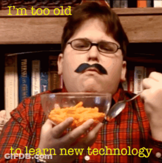 Man With Mustache And Glasses Eating Cheese Puffs GIF