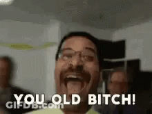 Man With Mustache And Glasses Laughing Saying You Old Bitch GIF