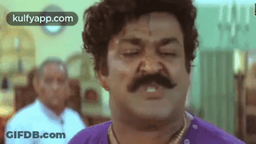 Man With Mustache And Purple Shirt Making Funny Face GIF