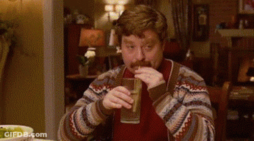 Man With Mustache Drinking From Glass At Table GIF