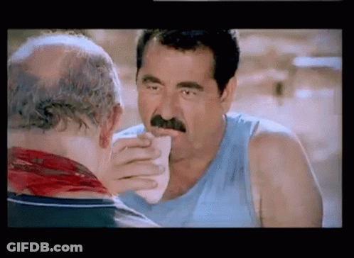 Man With Mustache Eating Sandwich From Another Man GIF