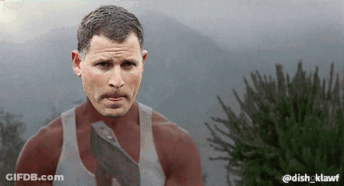 Man With Mustache Holding Axe In Front Of Mountains GIF