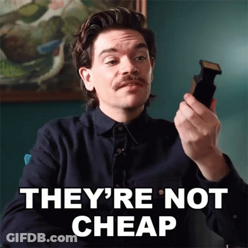 Man With Mustache Holding Cell Phone Saying They're Not Cheap GIF