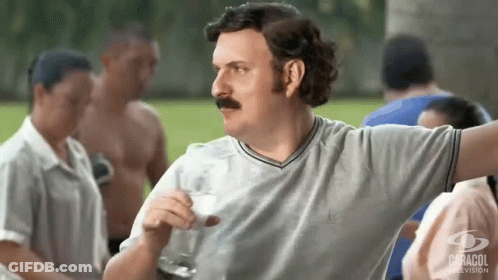 Man With Mustache Holding Glass Of Milk In Front Of Crowd GIF
