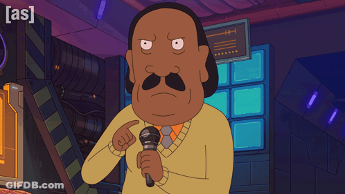 Man With Mustache Holding Microphone In Front Of As Sign GIF