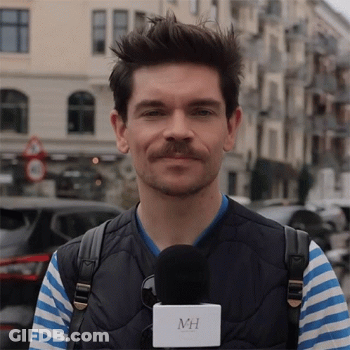 Man With Mustache Holding Microphone With MH GIF