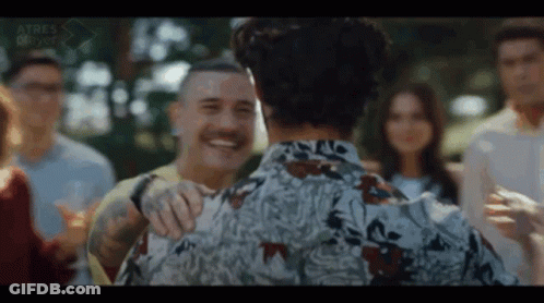 Man With Mustache Hugging Another In Group GIF