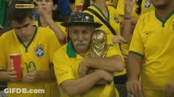 Man With Mustache Hugging Trophy In Crowd GIF