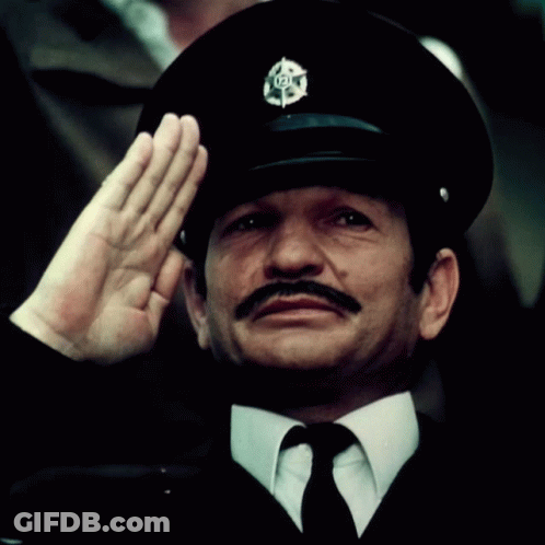 Man With Mustache In Black Hat With 101 Badge GIF