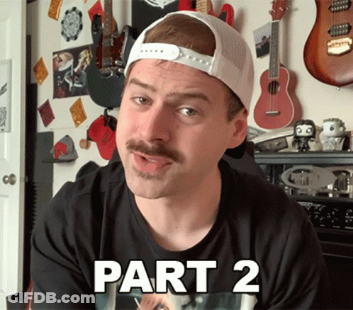 Man With Mustache In Black Shirt And White Hat Says Part 2 GIF